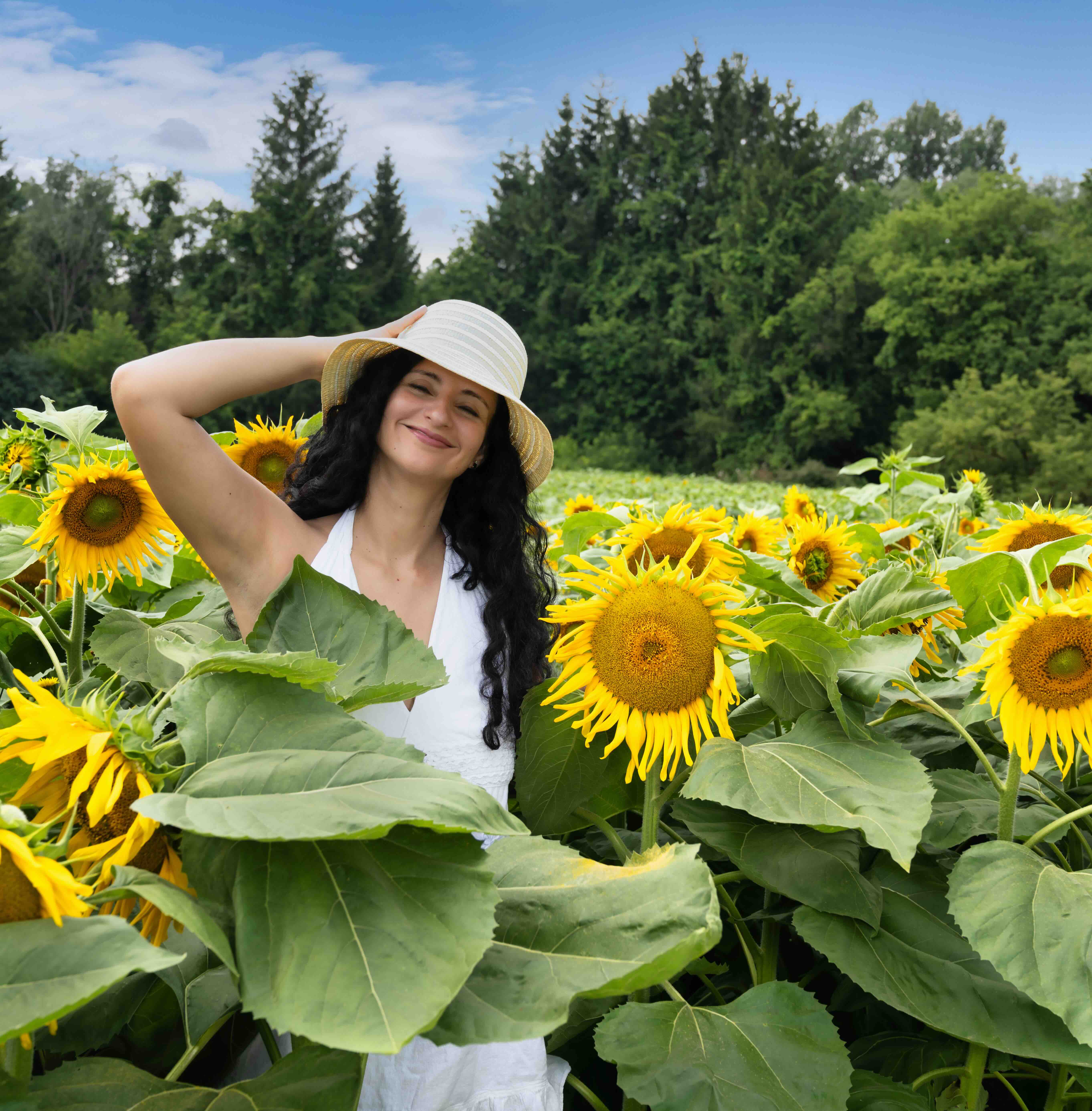Gisele Taraba standing in a sunflower field