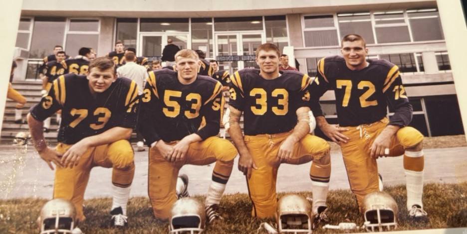 Tom (left) poses with his teammates